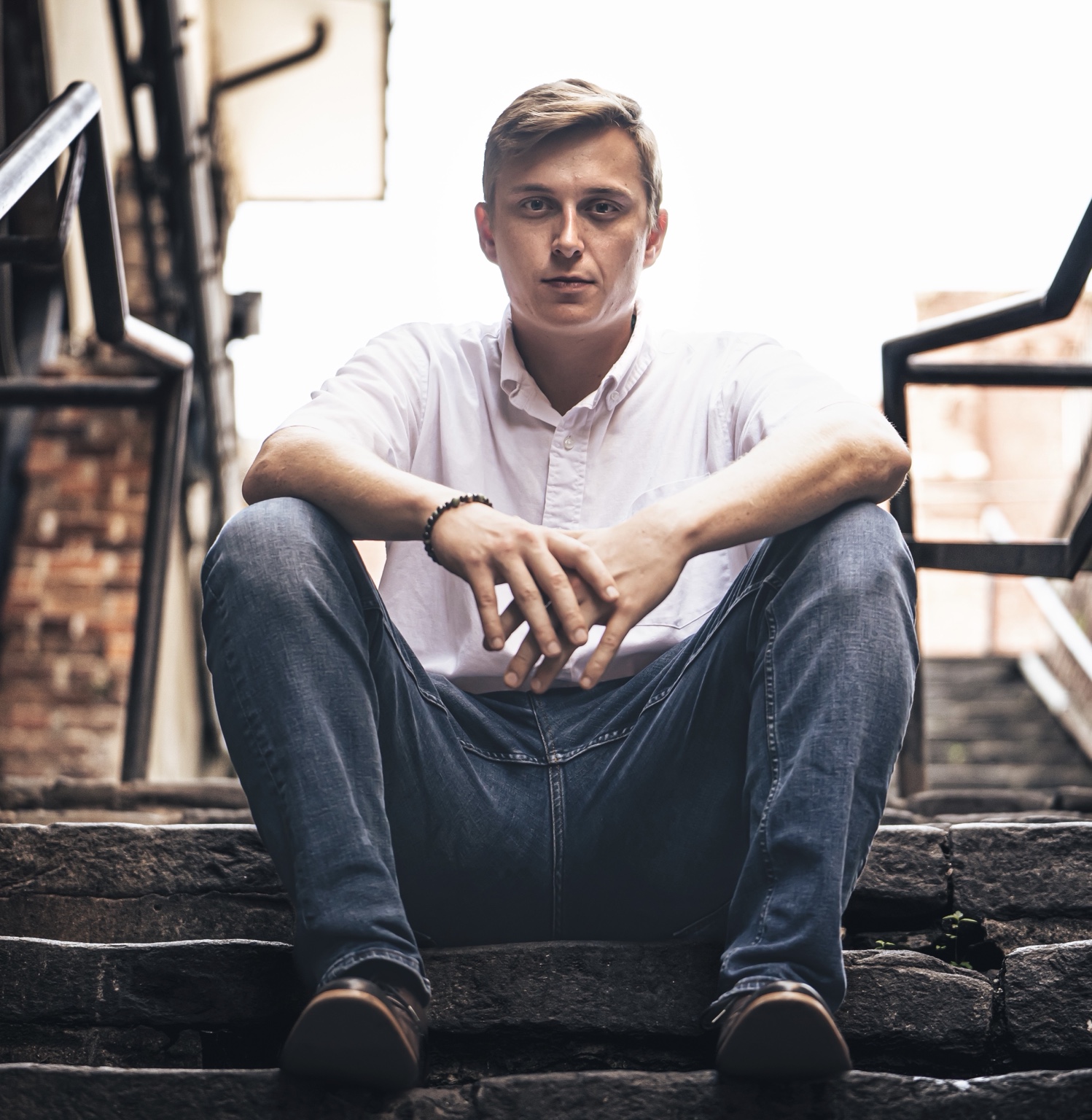 Mark Brown seated on stone steps